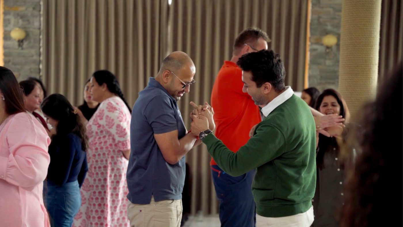 Two participants sharing a joyful moment during a group exercise